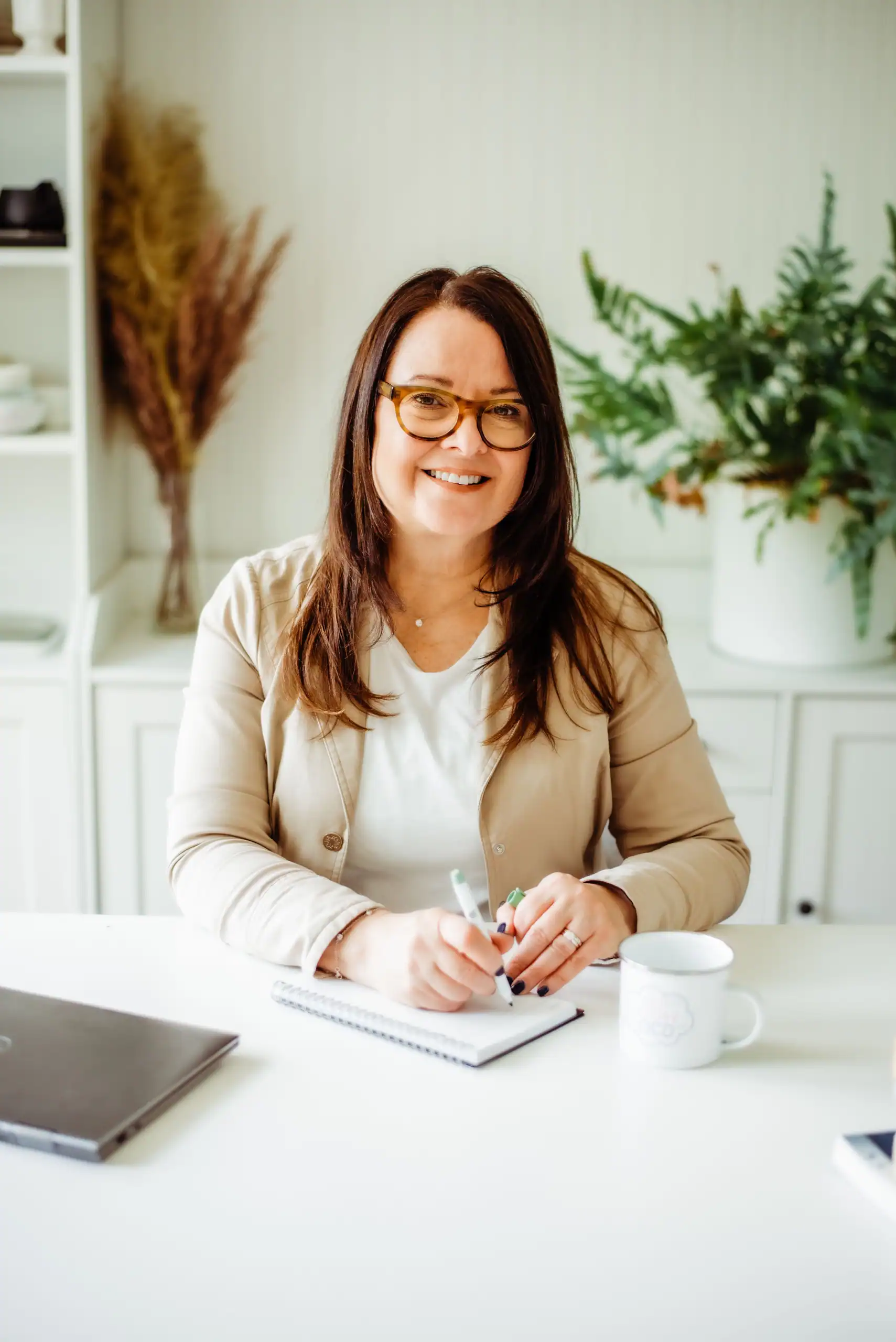 Anna Schneiderman, CBT therapist in Charlotte NC, at her desk — thoughtful, organized workspace reflecting the structured approach of Cognitive Behavioral Therapy